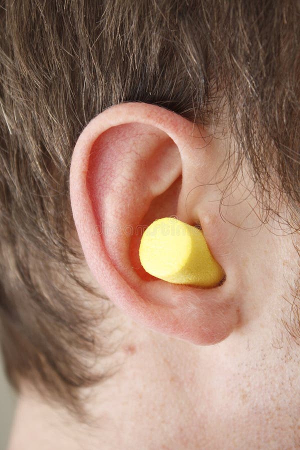 Ear plug in a male ear. Ear plug in a male ear