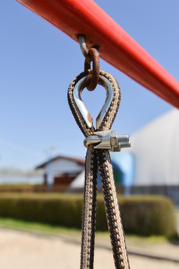 End of swinging rope hang on metal construction in a park. Rough