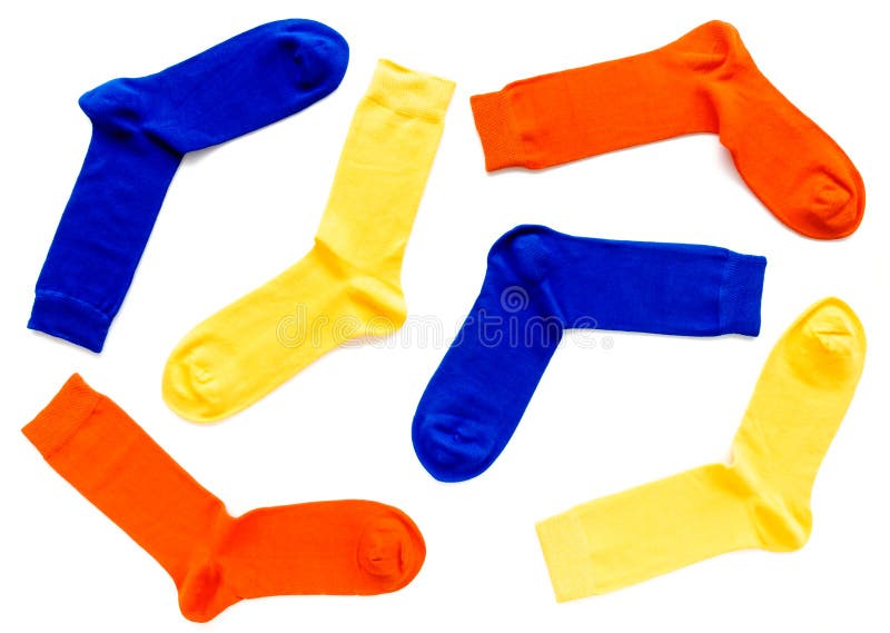 Flat lay of brightly colored trendy bamboo socks with hand linked toes in orange, yellow and blue colors on white background. Flat lay of brightly colored trendy bamboo socks with hand linked toes in orange, yellow and blue colors on white background.