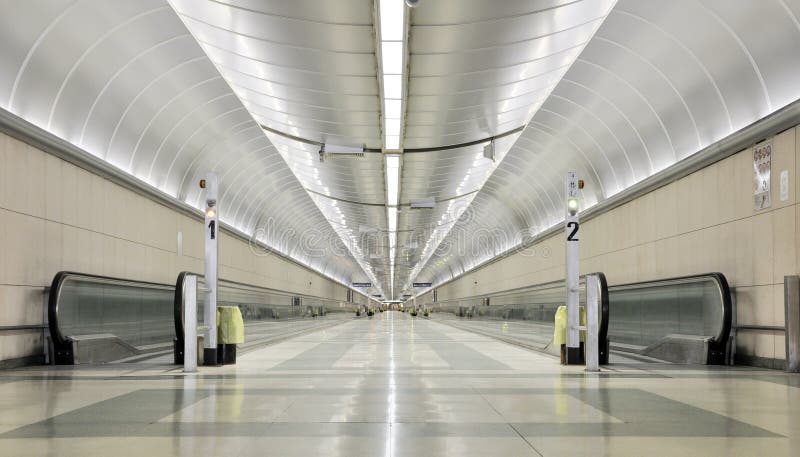 An endless and futuristic corridor in a train station. An endless and futuristic corridor in a train station