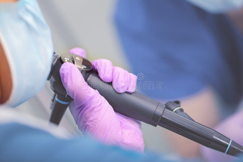 Endoscope in doctor`s hand during medical test. Endoscope in doctor`s hand during medical test.