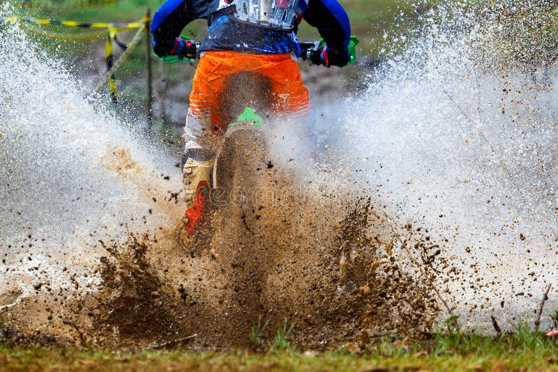 Enduro Motocross mud,Motocross racer in a wet and muddy terrain covering the driver completely.