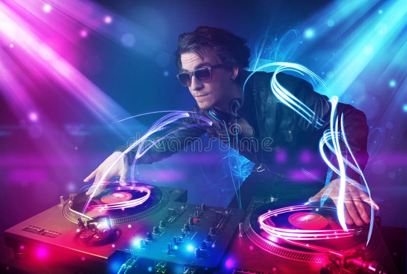 Energetic Dj Mixing Music with Powerful Light Effects Stock Photo