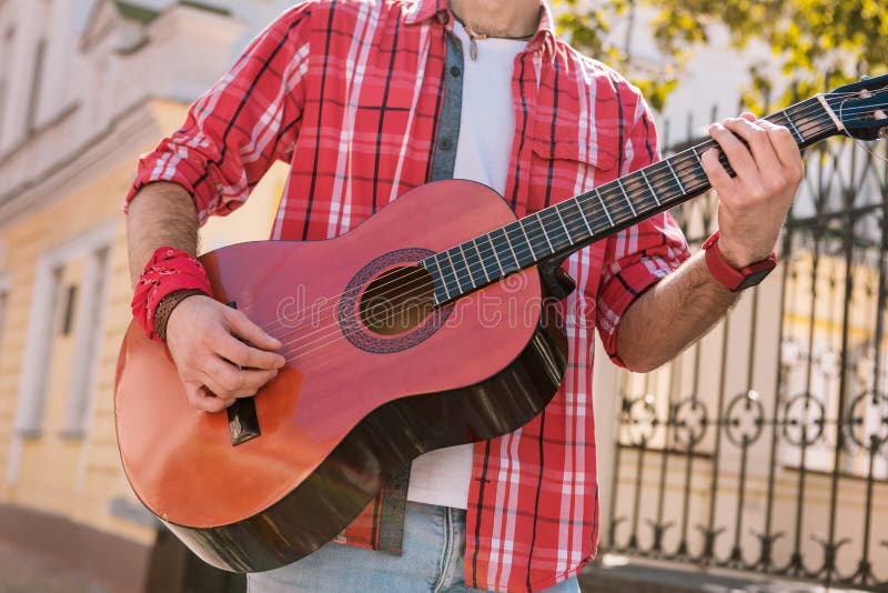 Energetic street musician granting song on street stock photos Energetic street musician granting song on street stock photos