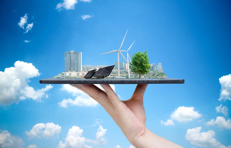 Ecological system solar energy in the city on the hand holding the tablet. Ecological system solar energy in the city on the hand holding the tablet