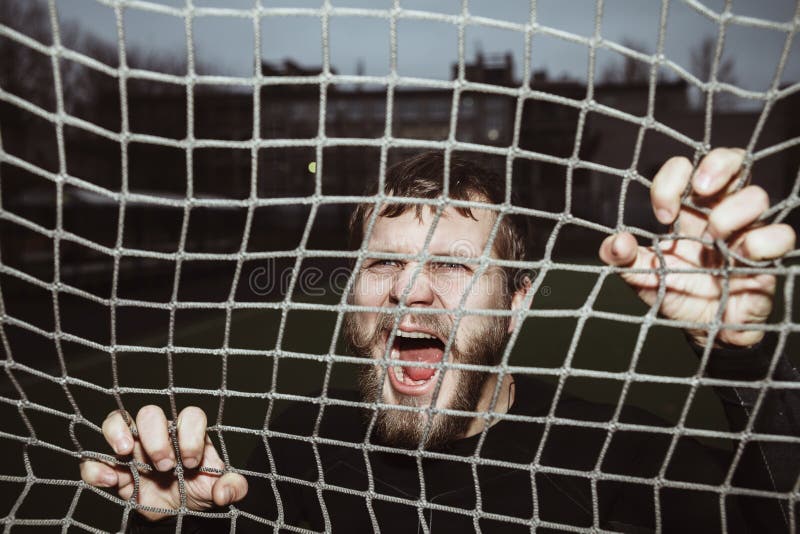 Energy furious bearded athlete screaming holding net royalty free stock images Energy furious bearded athlete screaming holding net royalty free stock images