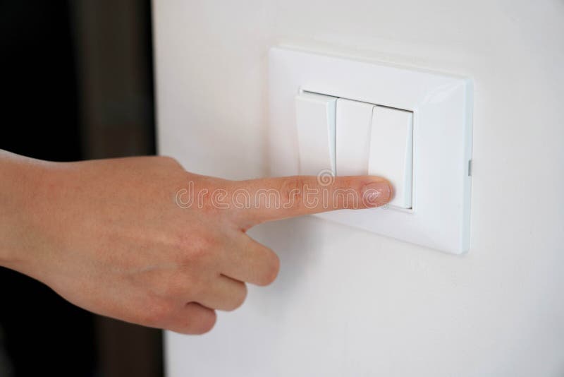 Energy Saving. Female Finger is Turn Off on Lighting Switch Stock Photo