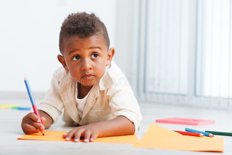 Preschool child boy drawing on the floor. Preschool child boy drawing on the floor