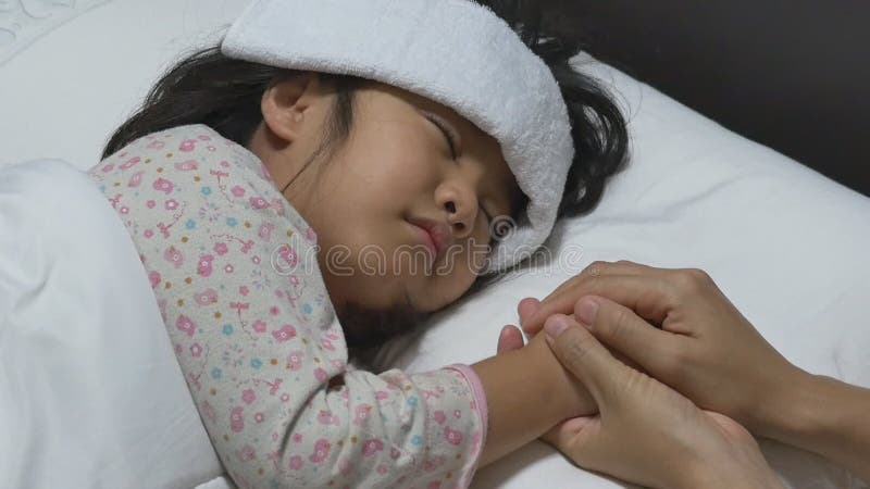 Enfant asiatique malade et dormant sur le lit