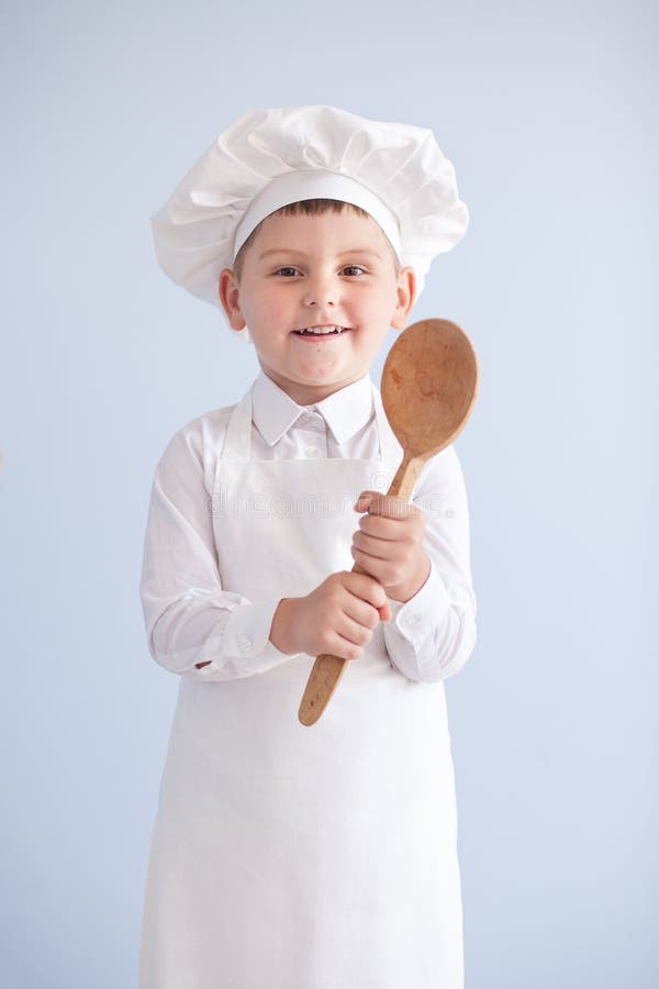 Enfant dans un chef de costume et de chapeau cuisinier photo stock Enfant dans un chef de costume et de chapeau cuisinier photo stock