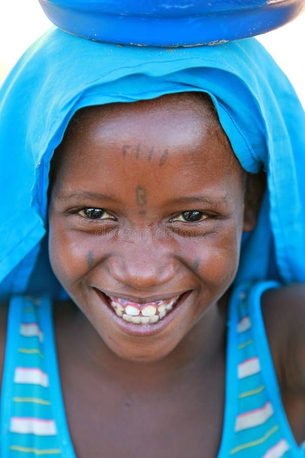 Young tattooed girl with a bucket on her head. Young tattooed girl with a bucket on her head