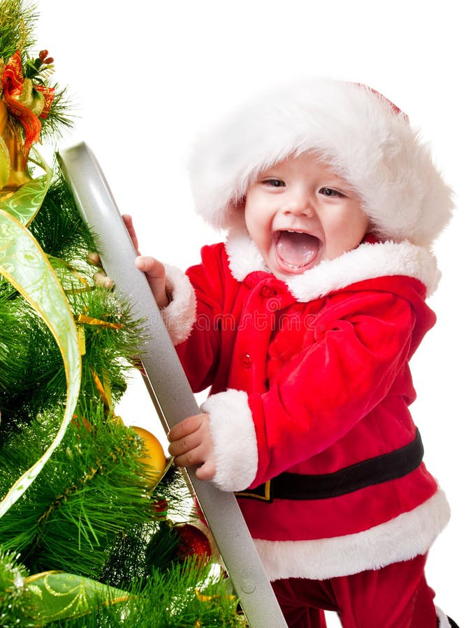 Enfant en bas âge décorant l'arbre de Noël photo stock Enfant en bas âge décorant l'arbre de Noël photo stock
