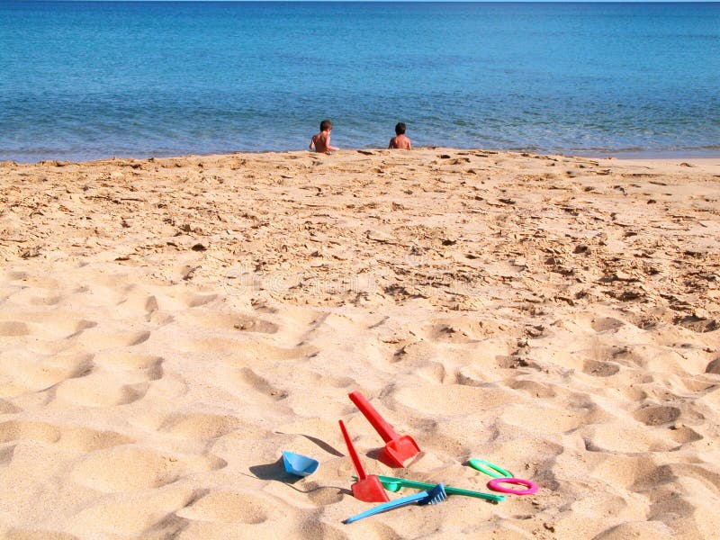 Children on a beach with sand toys. Children on a beach with sand toys