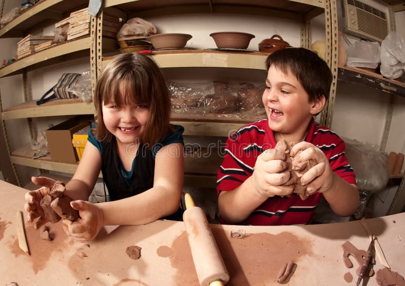 Cute kids working with clay in an art studio. Cute kids working with clay in an art studio