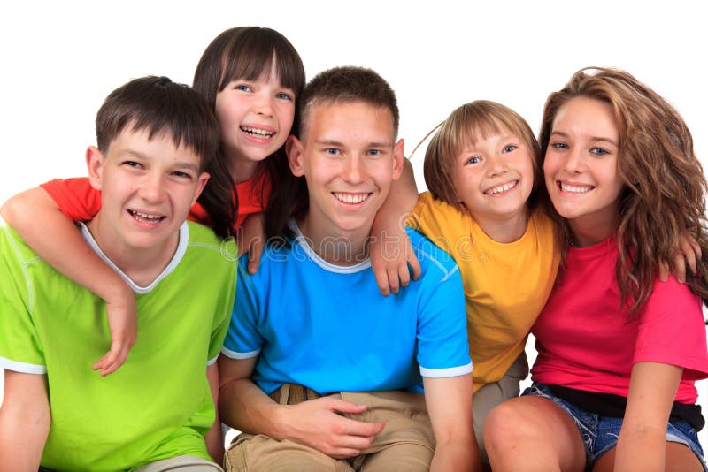 Five happy smiling siblings wearing colorful tee shirts against a white background. Five happy smiling siblings wearing colorful tee shirts against a white background.