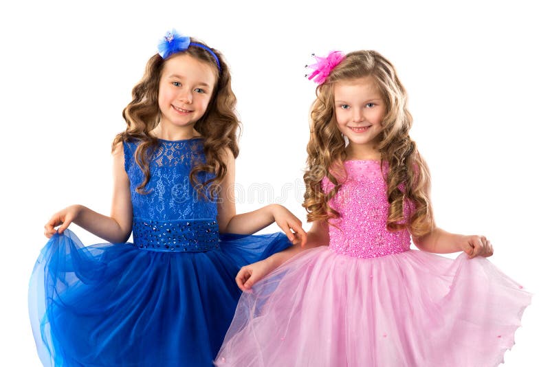 Enfants mignons, portrait de petites filles dans des robes de princesse, d'isolement sur le blanc photos stock Enfants mignons, portrait de petites filles dans des robes de princesse, d'isolement sur le blanc photos stock