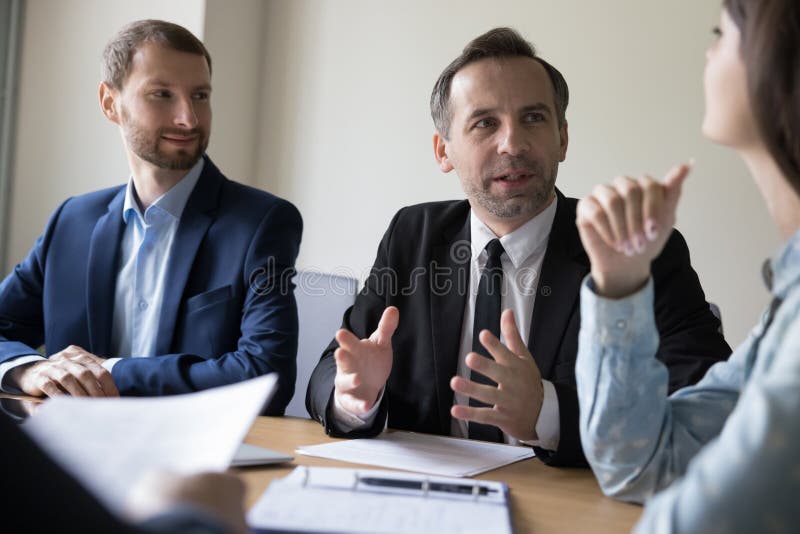 Engaged Mature Business Leader Man Talking To Younger Colleague Stock ...