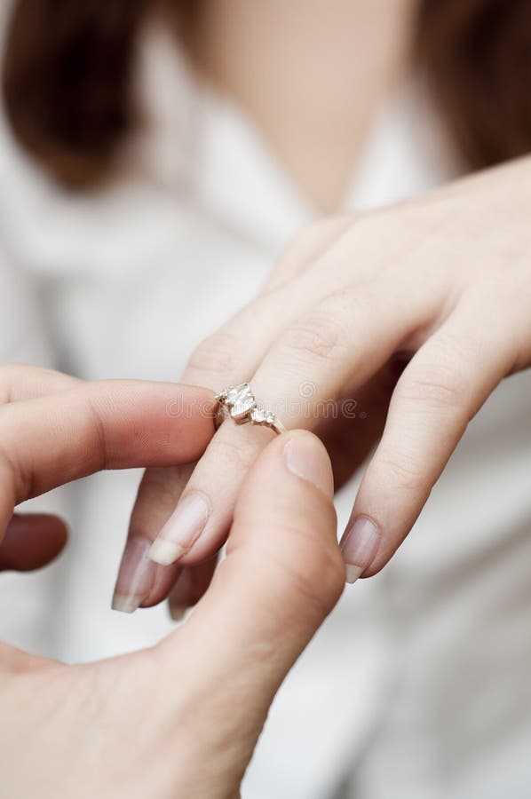 engagement ring into a finger