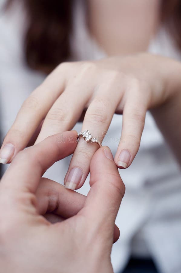 Engagement ring into a finger