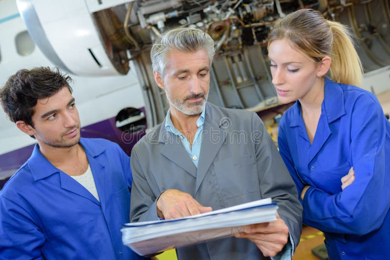 Engineer and apprentices checks aircraft systems royalty free stock photos Engineer and apprentices checks aircraft systems royalty free stock photos