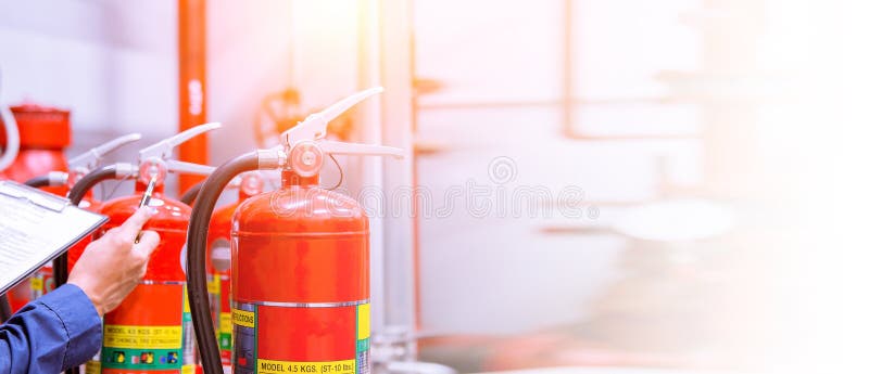 Engineer are checking and inspection a fire extinguishers tank in the fire control room for safety training and fire prevention. royalty free stock photos