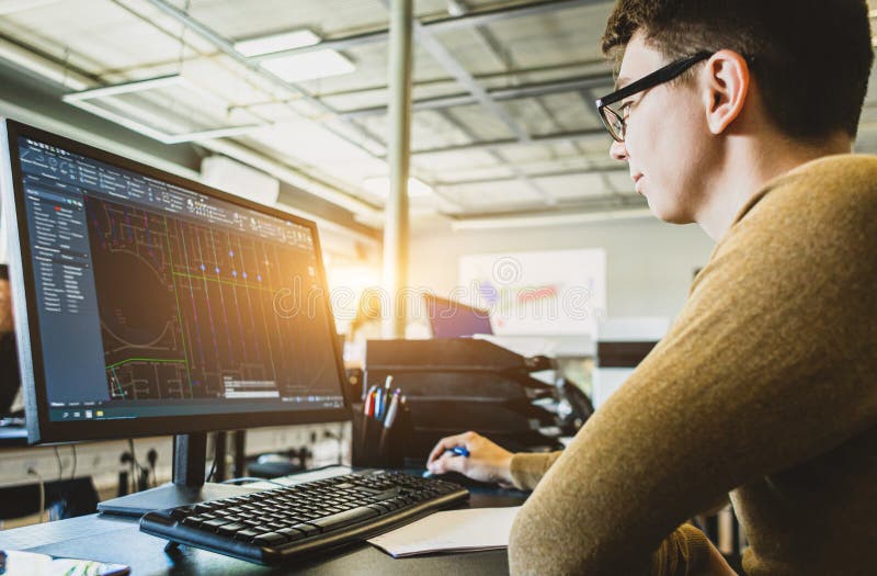 Engineer Designer Working on Desktop Computer in Factory Stock Image