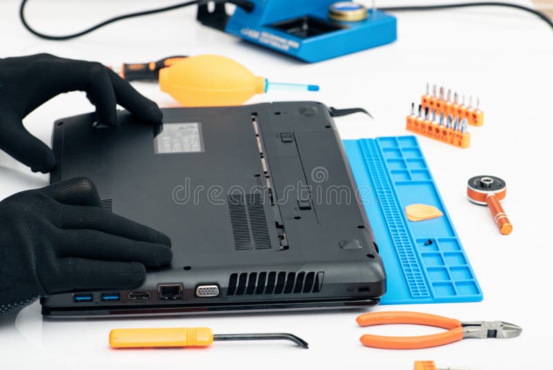 Engineer Dismantles the Details of a Broken Laptop for Repair Stock