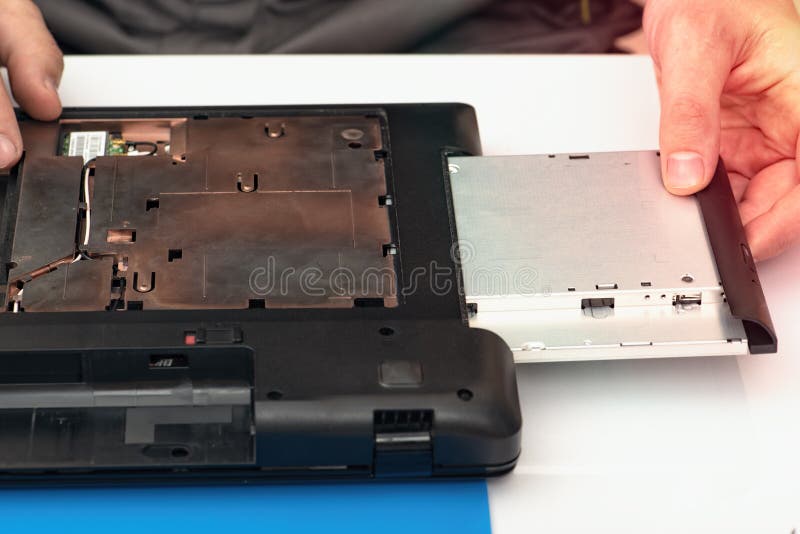 Engineer dismantles the details of a broken laptop for repair stock photos Engineer dismantles the details of a broken laptop for repair stock photos