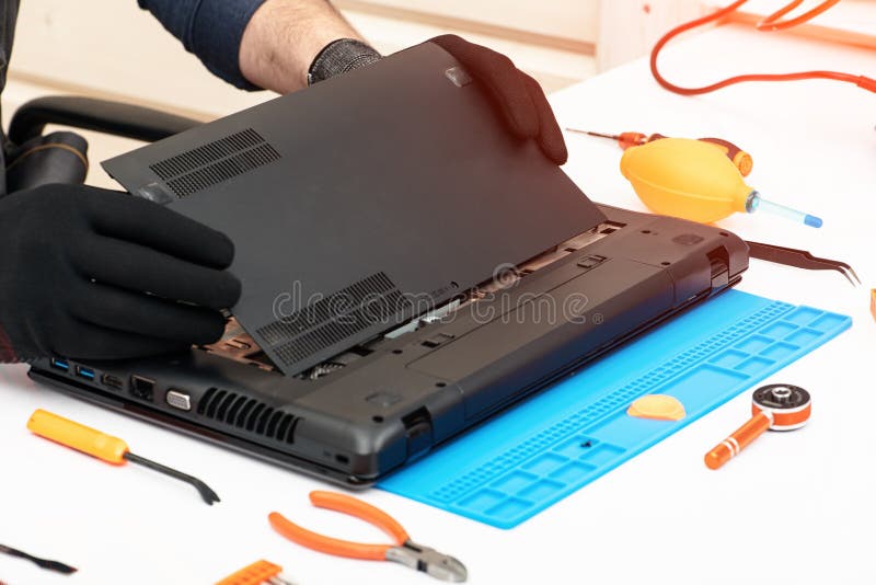Engineer dismantles the details of a broken laptop for repair stock images Engineer dismantles the details of a broken laptop for repair stock images