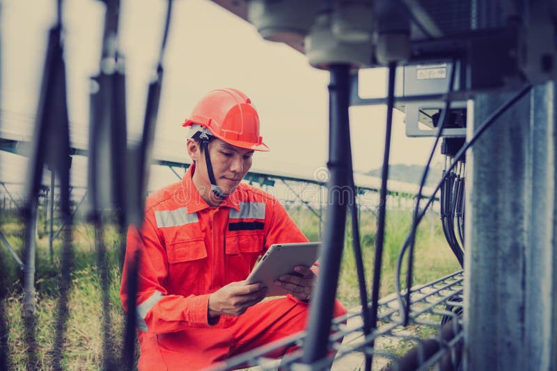Engineer or electrician holding laptop for inspect and checking string inverter by wifi technology ;smart technology for operate royalty free stock photography Engineer or electrician holding laptop for inspect and checking string inverter by wifi technology ;smart technology for operate royalty free stock photography