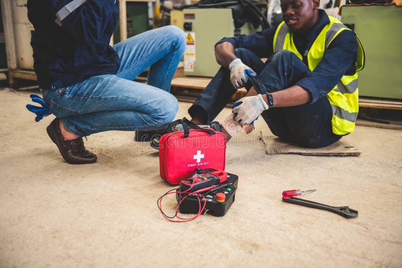 Engineer or foreman has an accident while working on steel factory workshop. Industry robot programming software for automated stock photo