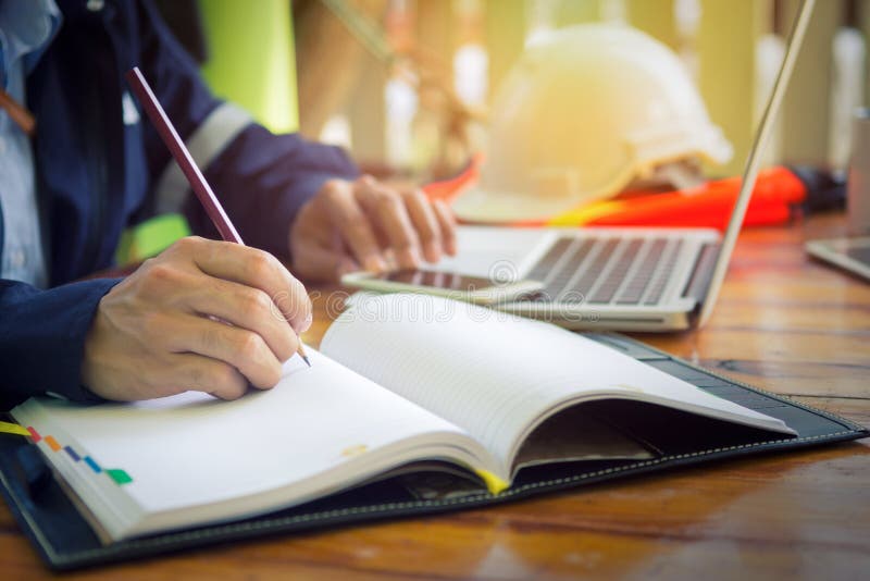 Engineer hand sketching a construction project with Pencil