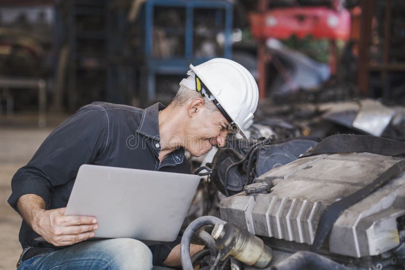 Engineer Holding Laptop Computer and Checking Spare Parts in Factory a