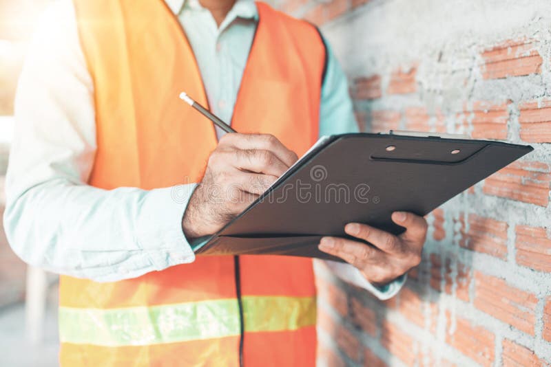 Engineer or inspector checking progressing work in construction site royalty free stock image Engineer or inspector checking progressing work in construction site royalty free stock image