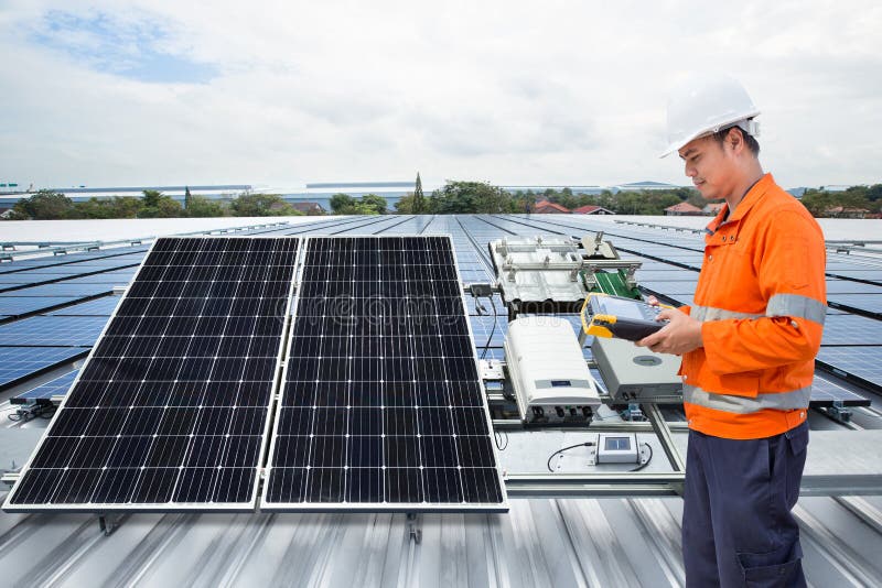 Engineer maintenance solar panel equipment on factory roof royalty free stock photo
