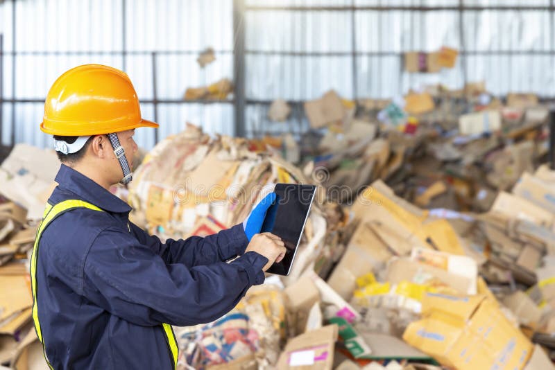 Engineer in a Paper Recycling Plant. Employees in a Paper Recycling