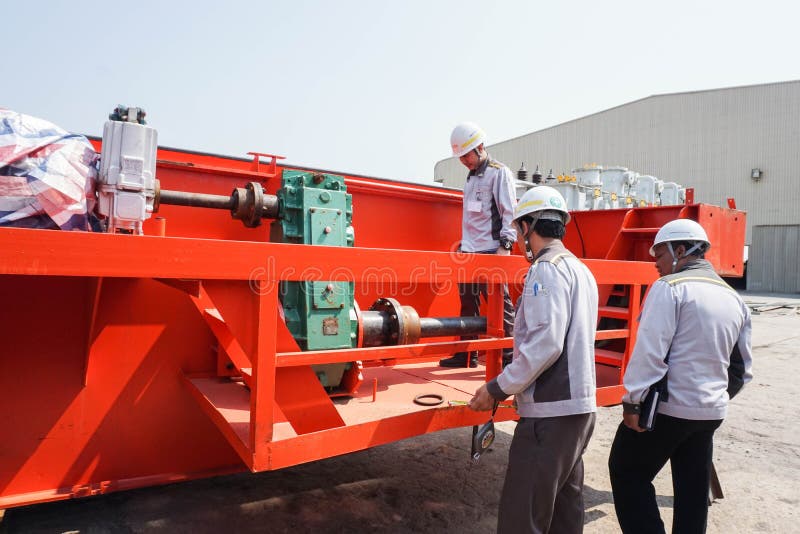 Engineer and QC team on duty repair the machinery of the crane royalty free stock photo Engineer and QC team on duty repair the machinery of the crane royalty free stock photo