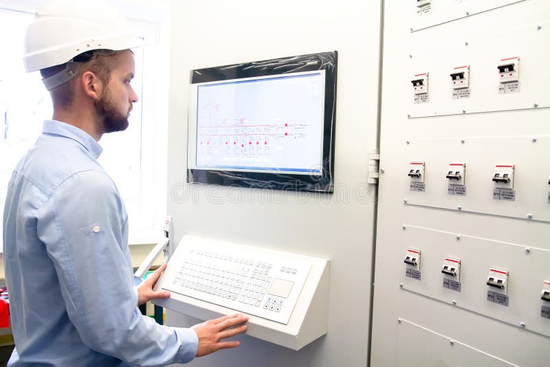 Engineer on remote controls electric power station stock photo