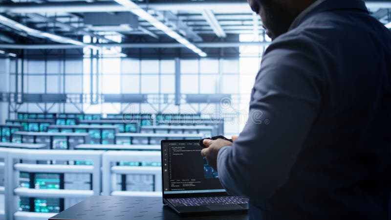 Engineer in server hub works with artificial intelligence computerized model stock photography