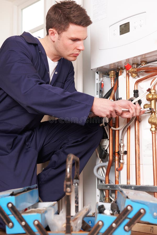 Engineer Servicing Central Heating Boiler royalty free stock photo Engineer Servicing Central Heating Boiler royalty free stock photo