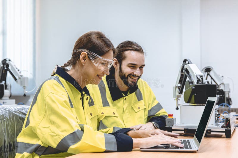 Engineer team software developer happy working together typing program source code for robot control royalty free stock photo