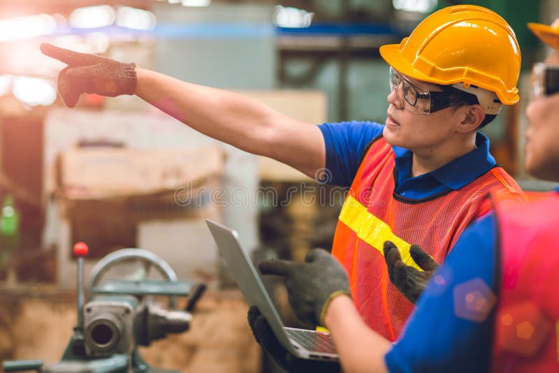 Engineer team working together in heavy industry with laptop computer discussion ordering worker join engineer teamwork