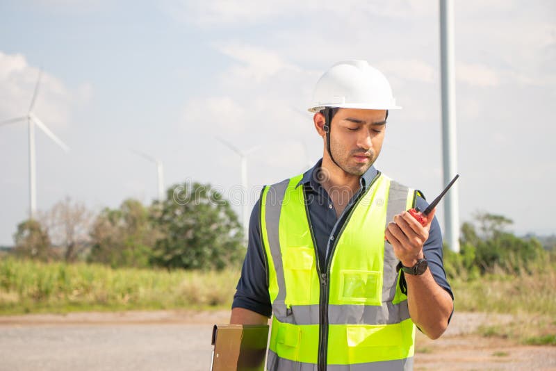 Engineer Team Working in Wind Turbine Farm. Renewable Energy with Wind