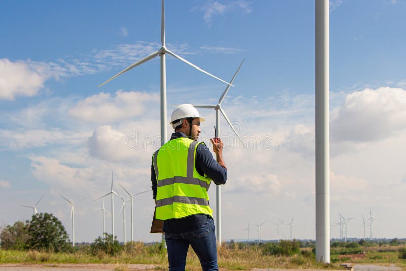 Engineer Team Working in Wind Turbine Farm. Renewable Energy with Wind