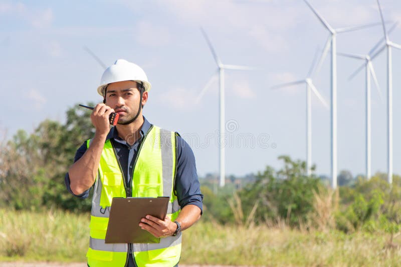 Engineer Team Working in Wind Turbine Farm. Renewable Energy with Wind