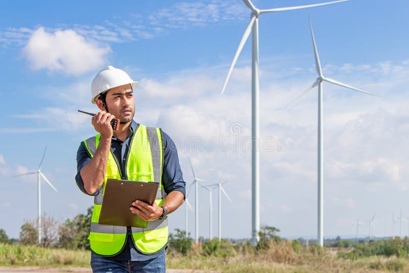 Engineer Team Working in Wind Turbine Farm. Renewable Energy with Wind