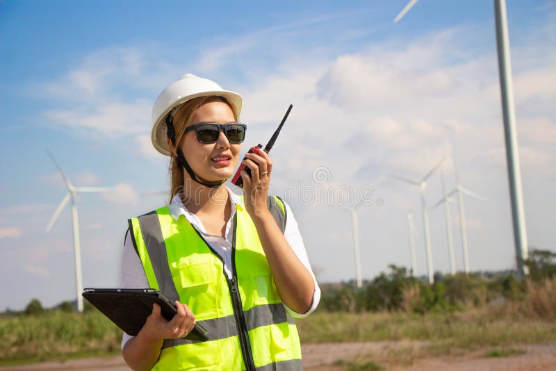 Engineer Team Working in Wind Turbine Farm. Renewable Energy with Wind