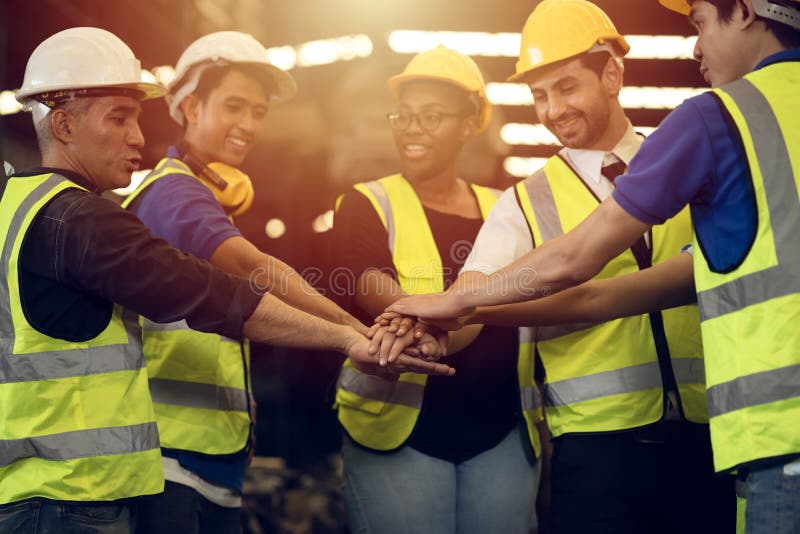 Engineer Teamwork Concept,Worker team join hands together in factory. People joining for cooperation success business of engineering partnership agreement of Architect engineer contractor mix race image photo picture.