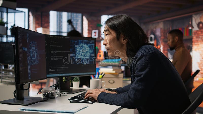 Engineer in tech startup office using AI machine learning systems on PC royalty free stock photos