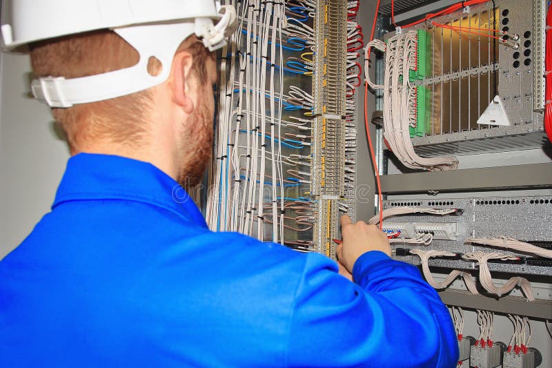 Engineer tests the automation cabinet with industrial equipment controllers royalty free stock image